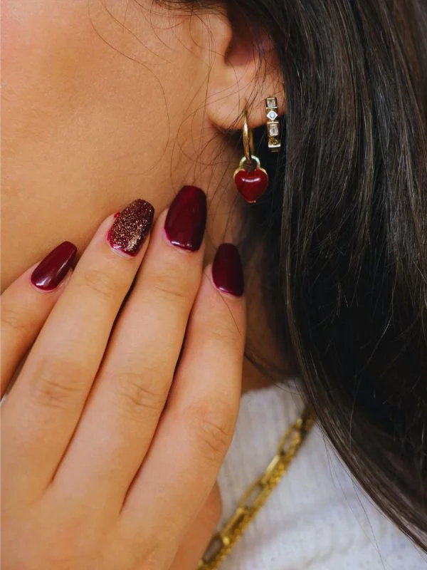 Photo by Esra Afşar httpswww.pexels.comphotoelegant-nail-art-with-heart-earring-close-up-29375277 (1)